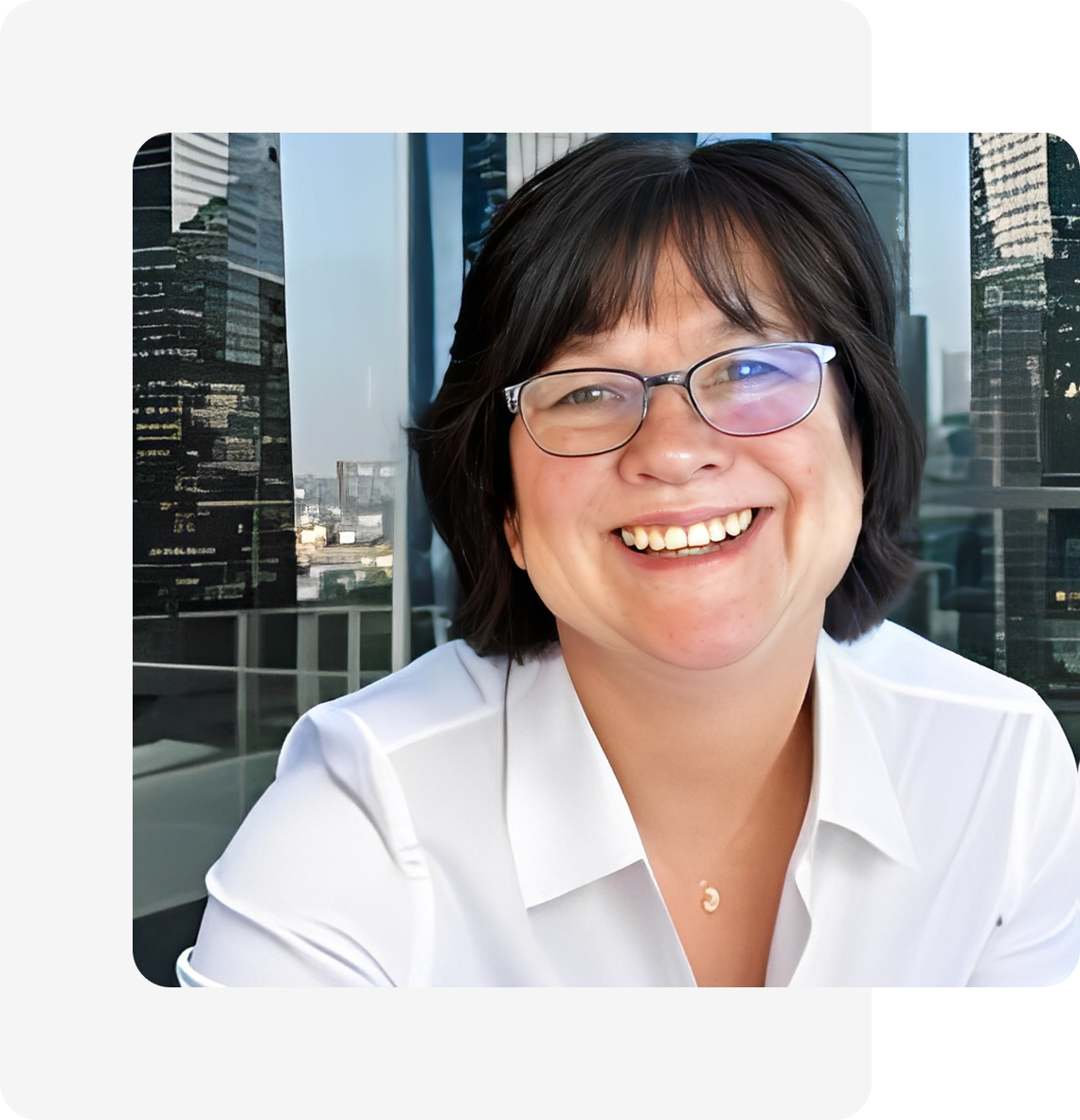 Smiling person wearing glasses in city backdrop.